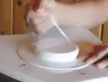 pulling the plastic from lid